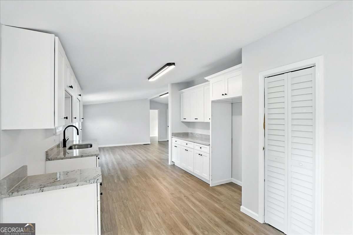 285 Trotters Way Jefferson, GA 30549 - Photo 8 of 28 a kitchen with granite countertop a sink and a refrigerator