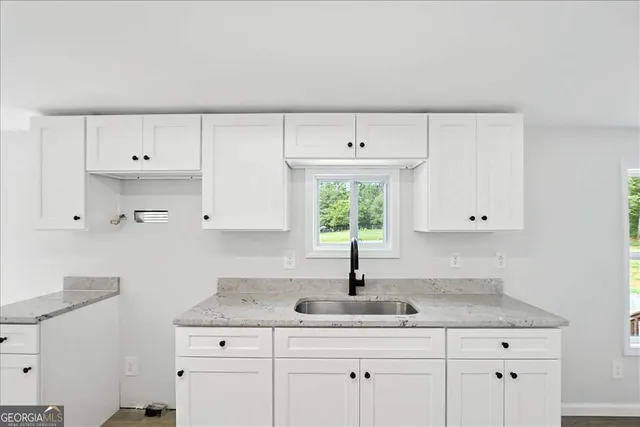 a kitchen with cabinets appliances and a sink
