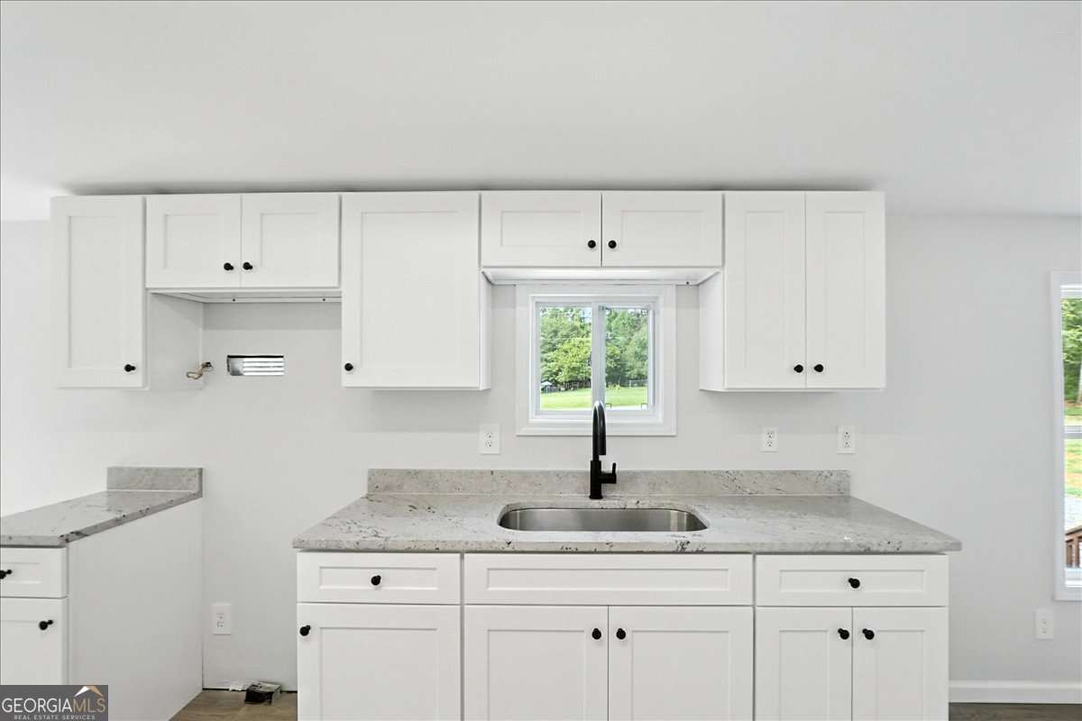 285 Trotters Way Jefferson, GA 30549 - Photo 9 of 28 a kitchen with cabinets appliances and a sink