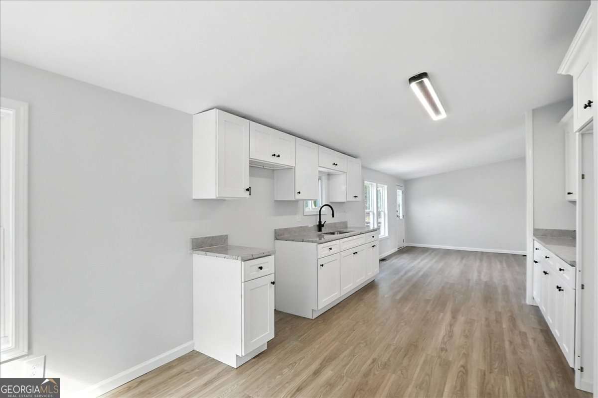 285 Trotters Way Jefferson, GA 30549 - Photo 10 of 28 a large kitchen with cabinets wooden floor and stainless steel appliances