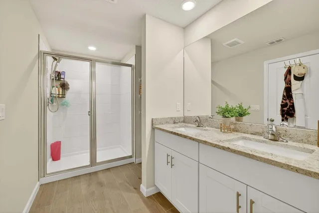 a bathroom with a granite countertop sink and a mirror
