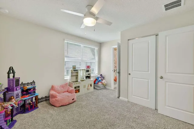 a livingroom with toys and a chandelier