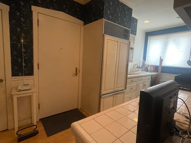 a kitchen with stainless steel appliances a refrigerator and a stove