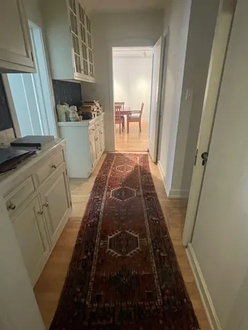a view of a kitchen with cabinets and wooden floor