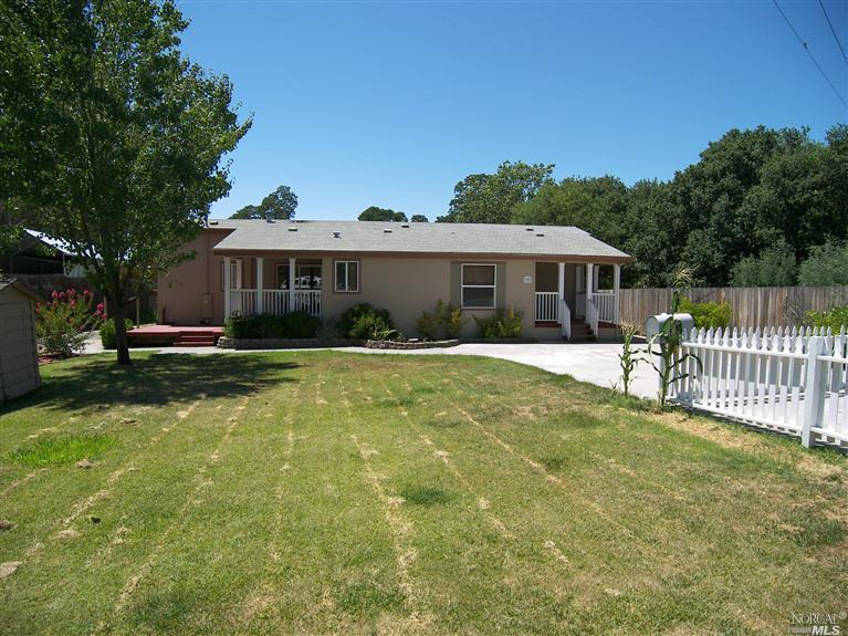 30 Wilcox Road Windsor, CA 95492 - Photo 1 of 1 a view of a house with a small yard and a large tree