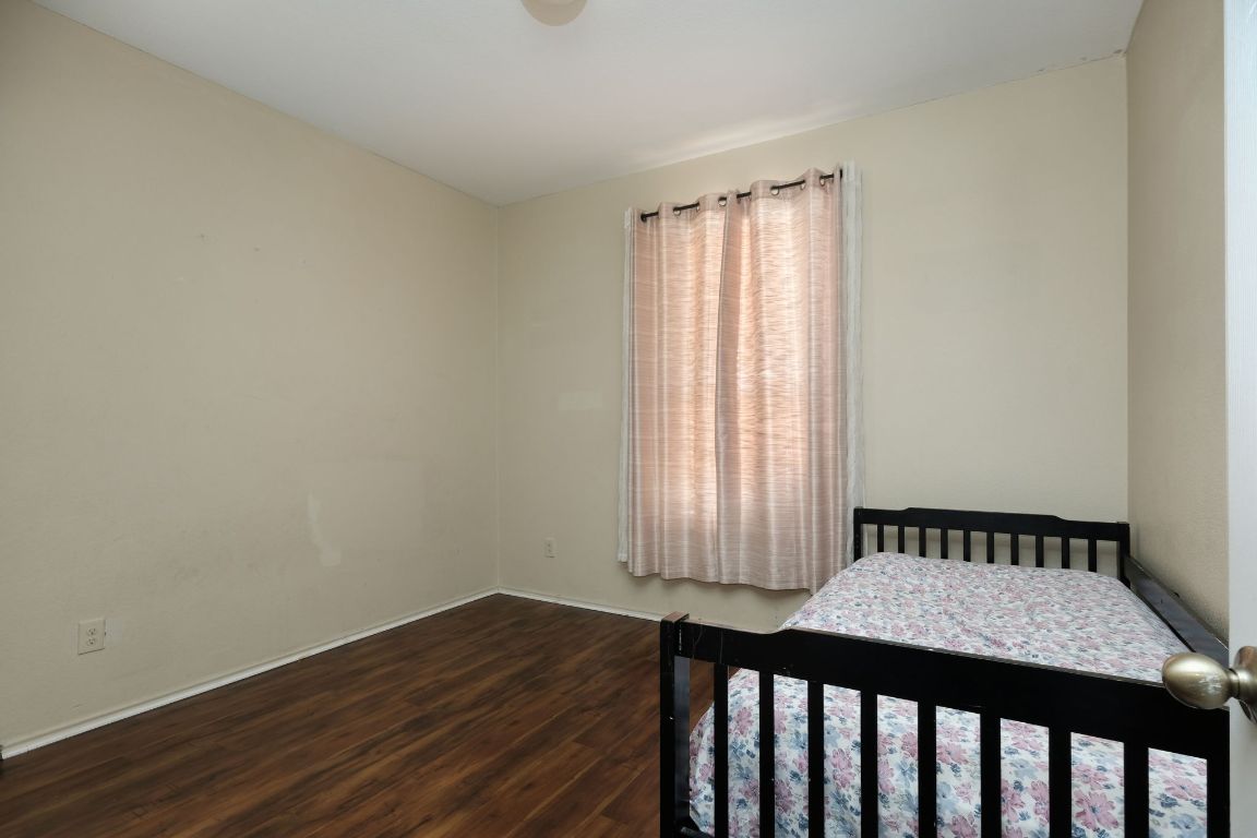 1244 Yellow Iris Road Leander, TX 78641 - Photo 16 of 25 a bedroom with a bed and wooden floor