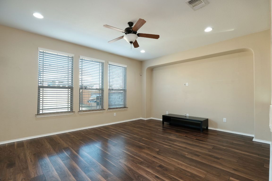 1244 Yellow Iris Road Leander, TX 78641 - Photo 4 of 25 a view of empty room with wooden floor and fan