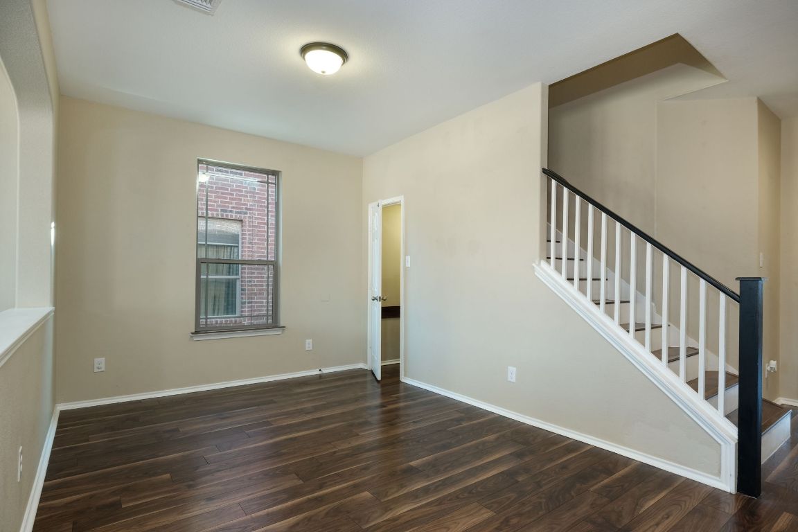 1244 Yellow Iris Road Leander, TX 78641 - Photo 5 of 25 a view of an empty room with wooden floor and a window