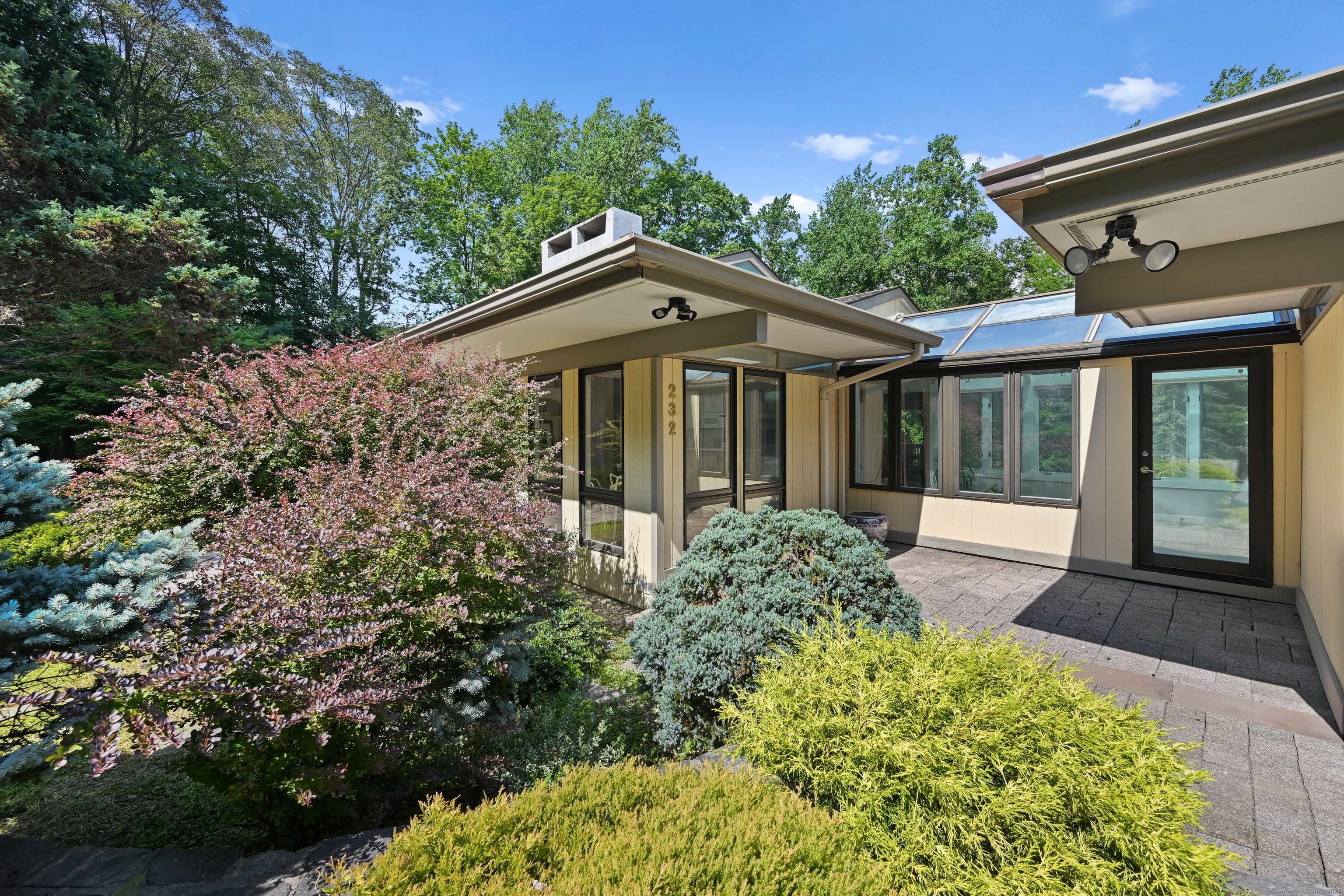 a front view of a house with a garden