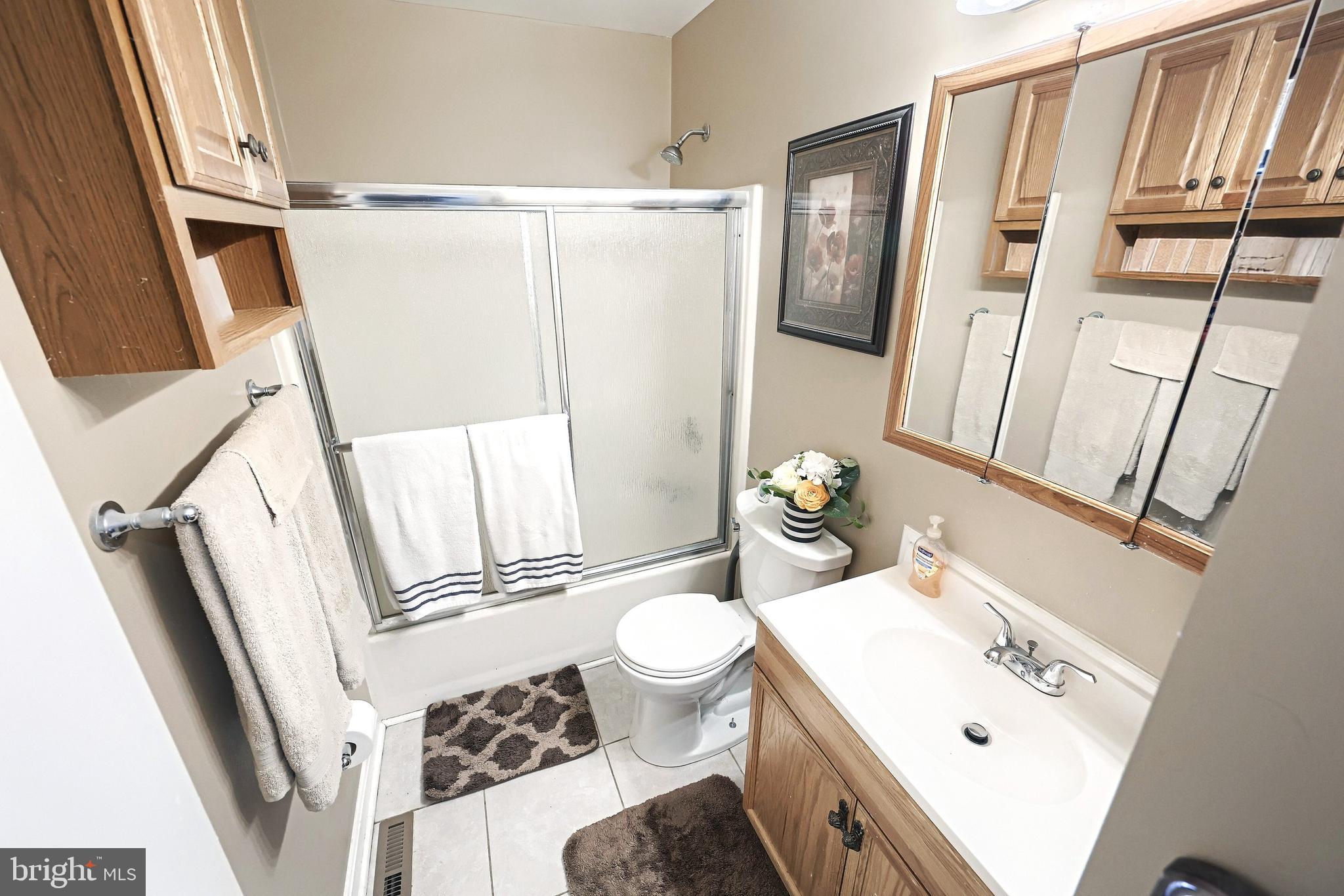 225 Edinburgh Road York, PA 17406 - Photo 14 of 40 a bathroom with a sink a toilet a mirror and shower curtain