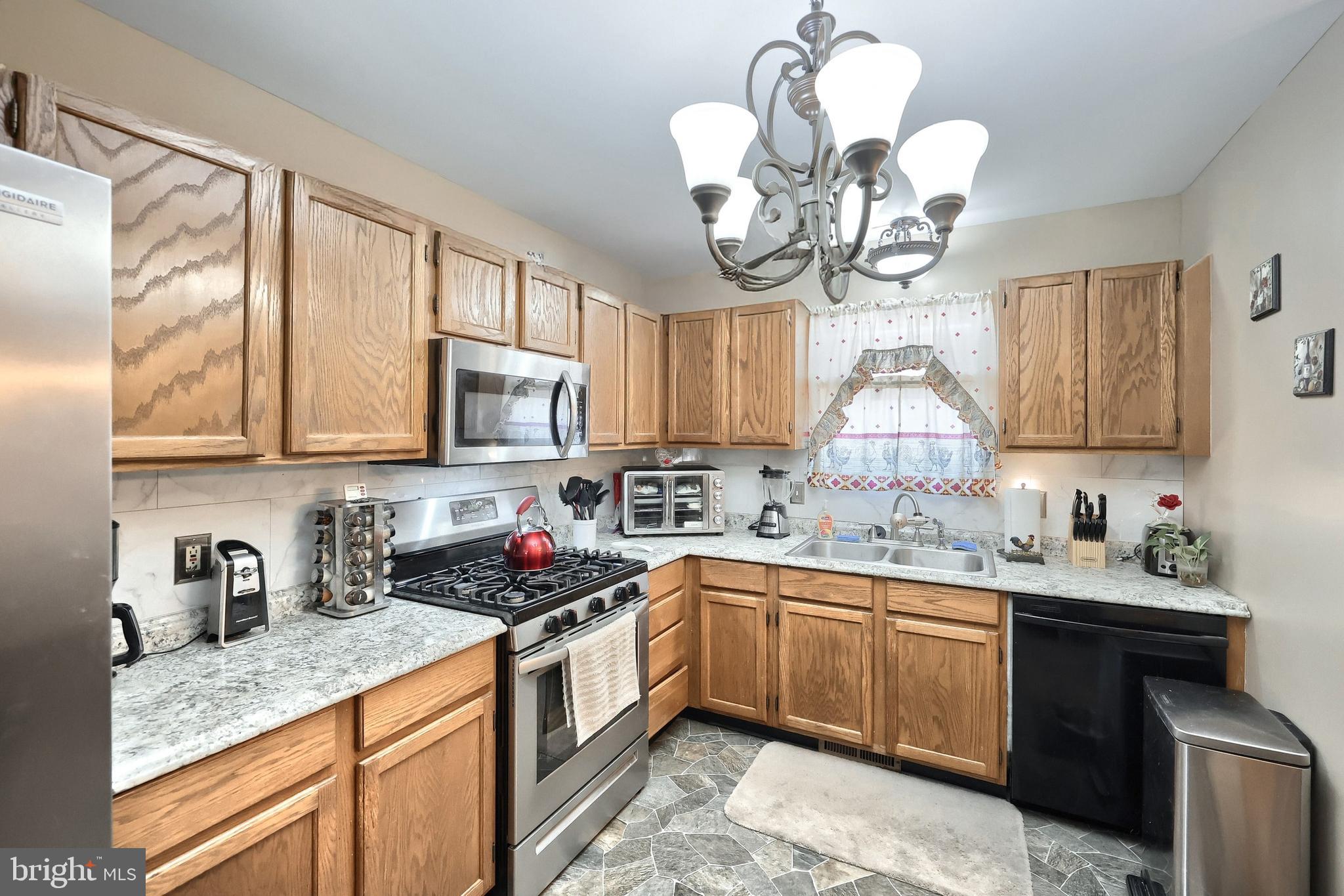 225 Edinburgh Road York, PA 17406 - Photo 6 of 40 a kitchen with a sink cabinets and window