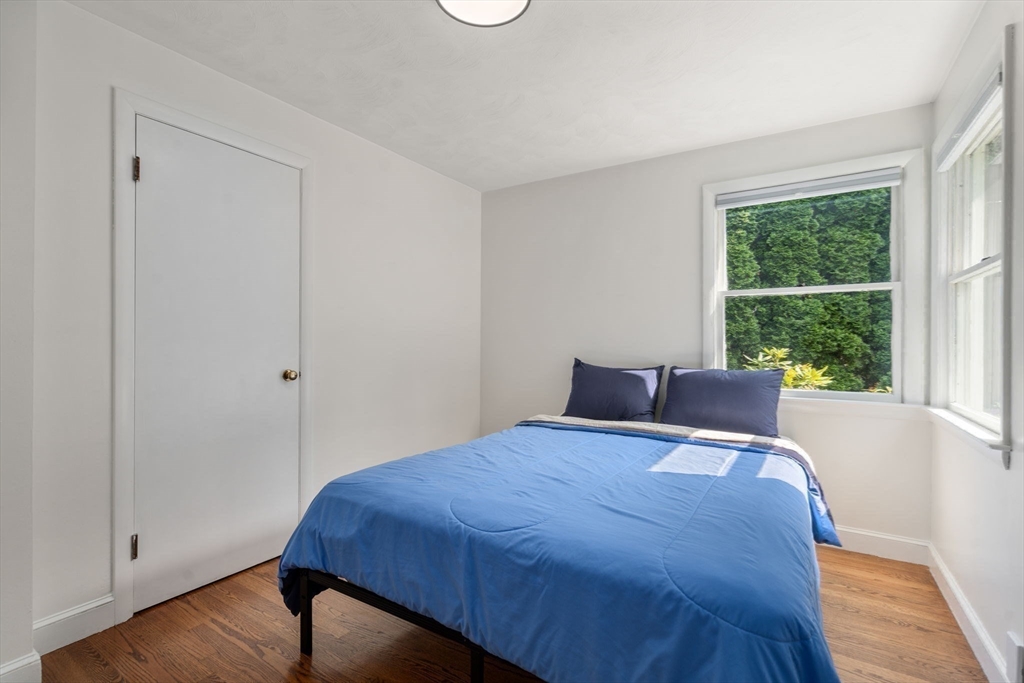 19 Wellesley Road Natick, MA 01760 - Photo 16 of 23 a bed sitting in a bedroom next to a window