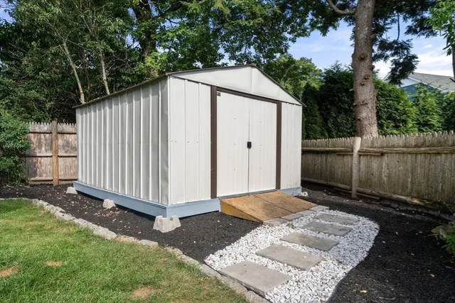 a backyard of a house with a small barn