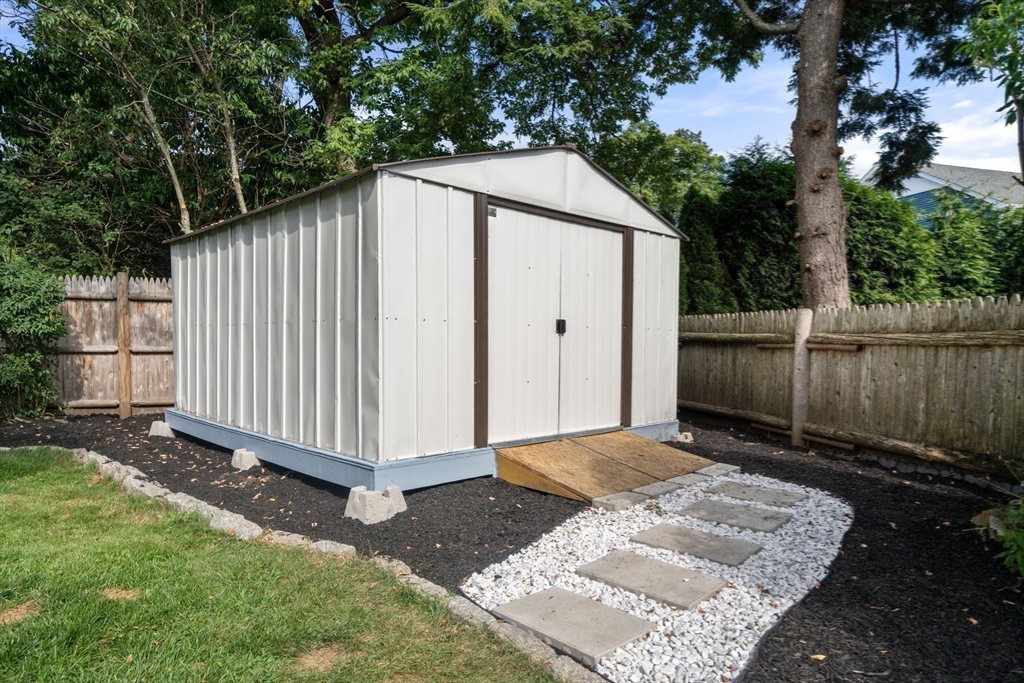 19 Wellesley Road Natick, MA 01760 - Photo 7 of 23 a backyard of a house with a small barn