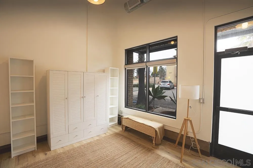 5065 Waterview Way, Unit 101 Oceanside, CA 92057 - Photo 11 of 19 a view of room with wooden floor and windows