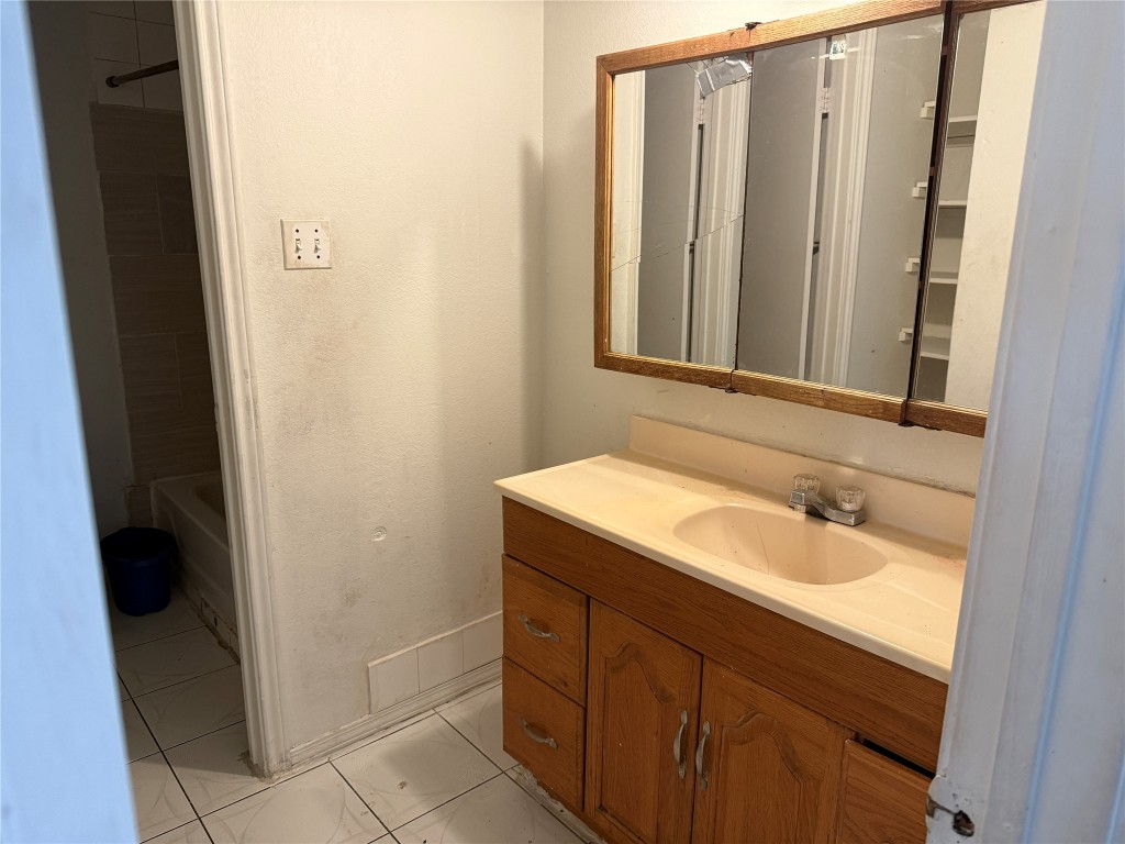 7703 Northcrest Boulevard Austin, TX 78752 - Photo 14 of 22 a bathroom with a sink and a mirror
