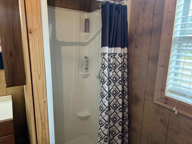 a view of walk in closet with clothes