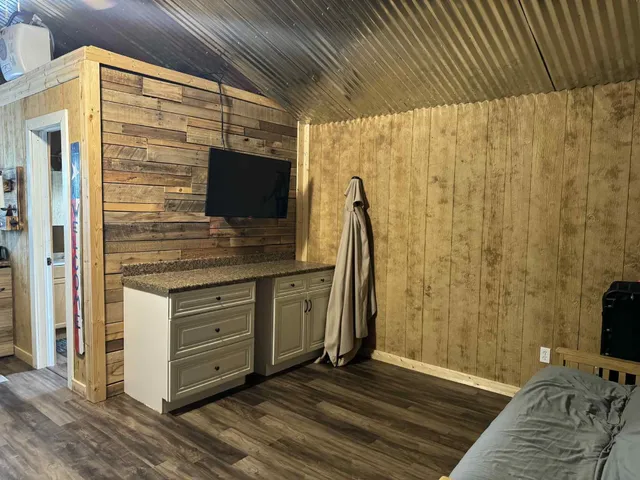 a kitchen with a sink a refrigerator and cabinets