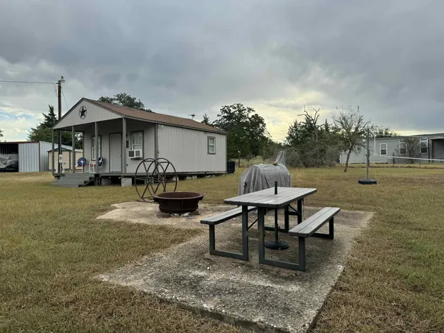 a view of a patio with table and chairs with wooden floor