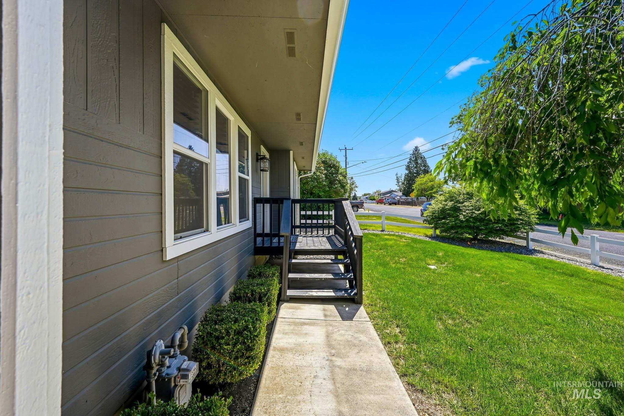 3715 18th Street Lewiston, ID 83501 - Photo 2 of 30 Modern gray siding exterior with white trim, featuring a front porch with dark railings and steps