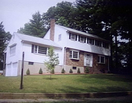 25 Old Coach Road Canton, MA 02021 - Photo 1 of 1 a front view of a house with a garden