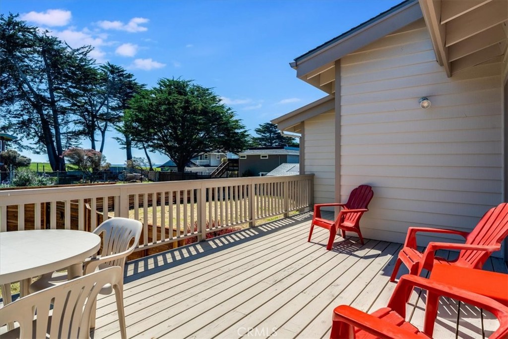 390 Lampton Street Cambria, CA 93428 - Photo 40 of 68 This sunny back deck is accessible from both the living area and the primary bedroom.