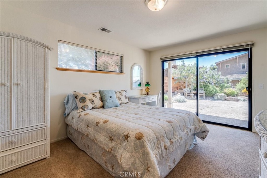390 Lampton Street Cambria, CA 93428 - Photo 43 of 68 Downstairs second bedroom has a walk-in closet and sliding glass door to the sideyard.
