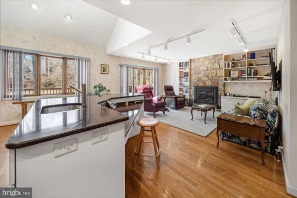 a living room with fireplace furniture and a large window