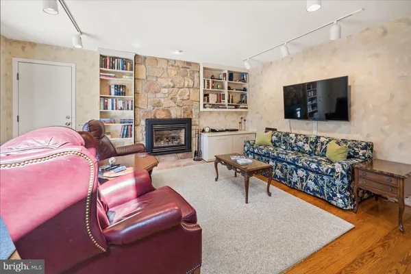 a living room with furniture fireplace and a flat screen tv