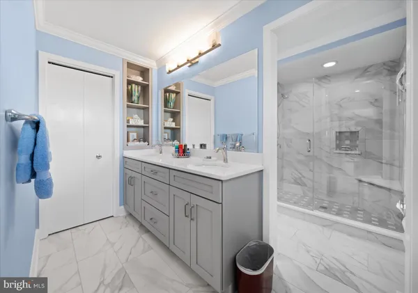 a bathroom with a granite countertop sink a toilet a mirror and shower