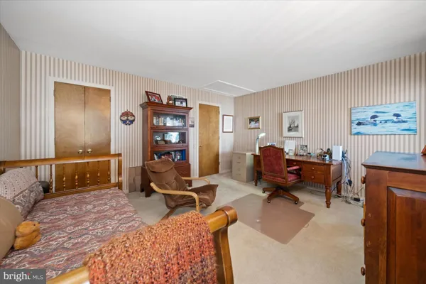 a bedroom with furniture or couch and a dresser