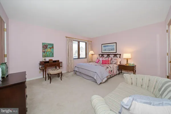 a bedroom with a bed and a couch