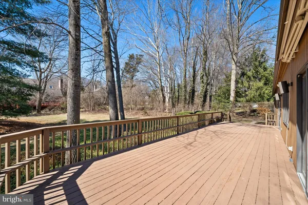 a view of balcony with wooden floor and fence