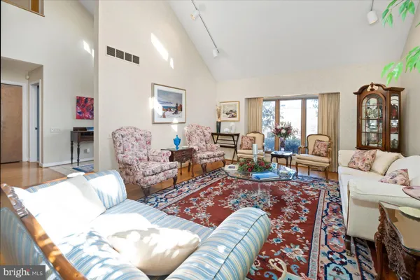 a living room with furniture fireplace and a window