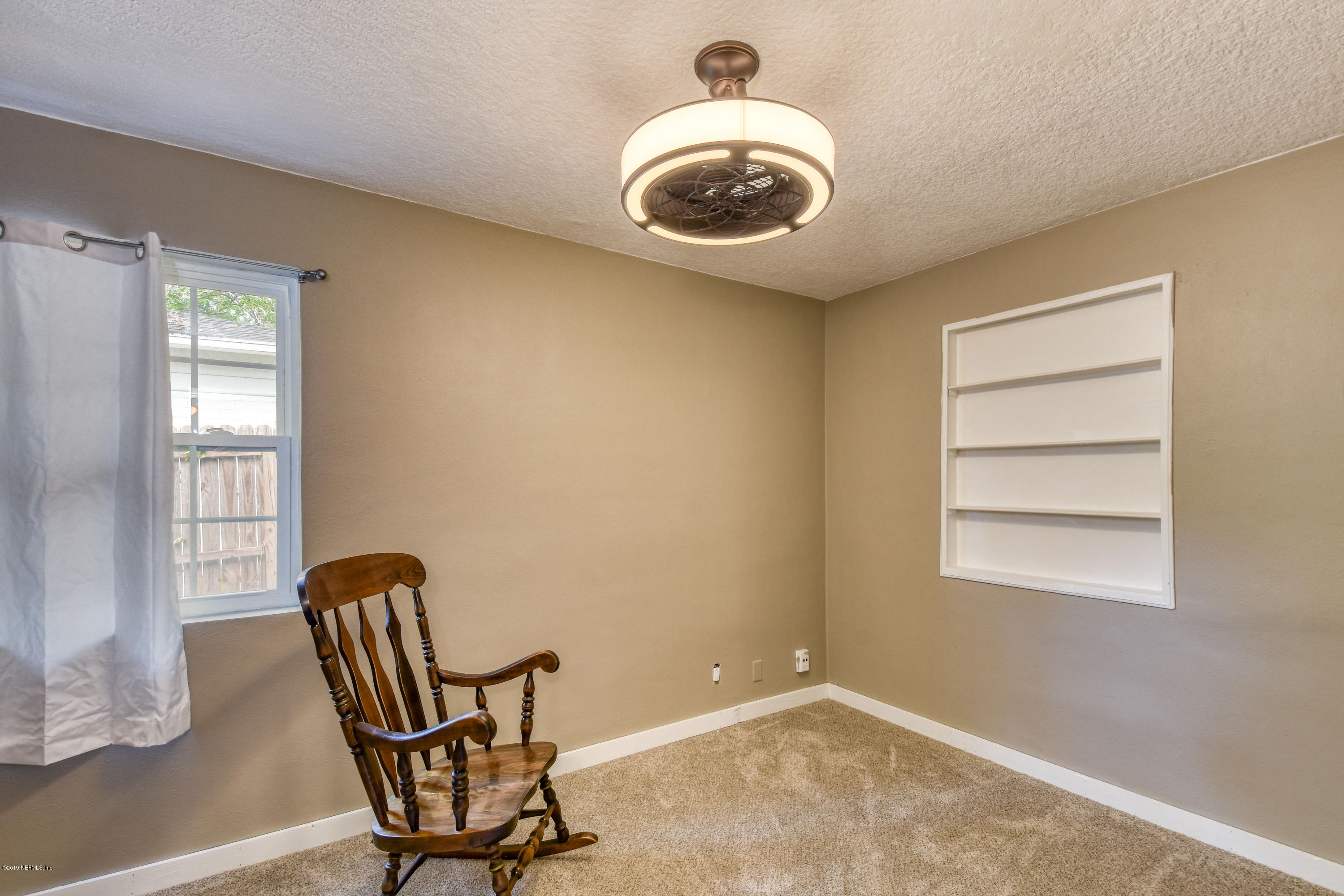 4623 Martingale Road Jacksonville, FL 32210 - Photo 12 of 18 a view of a room with a lounge chair and windows