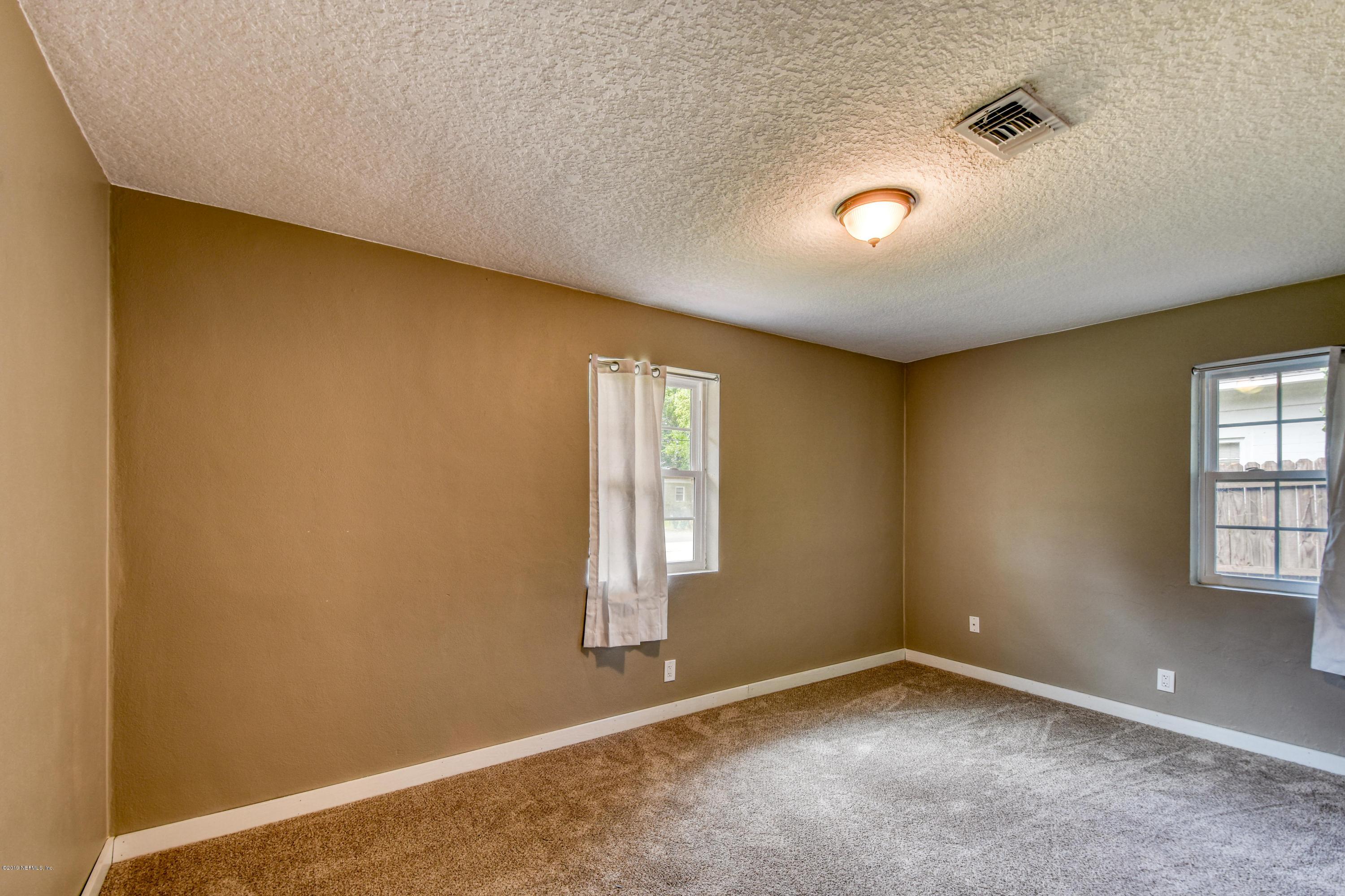 4623 Martingale Road Jacksonville, FL 32210 - Photo 13 of 18 an empty room with windows