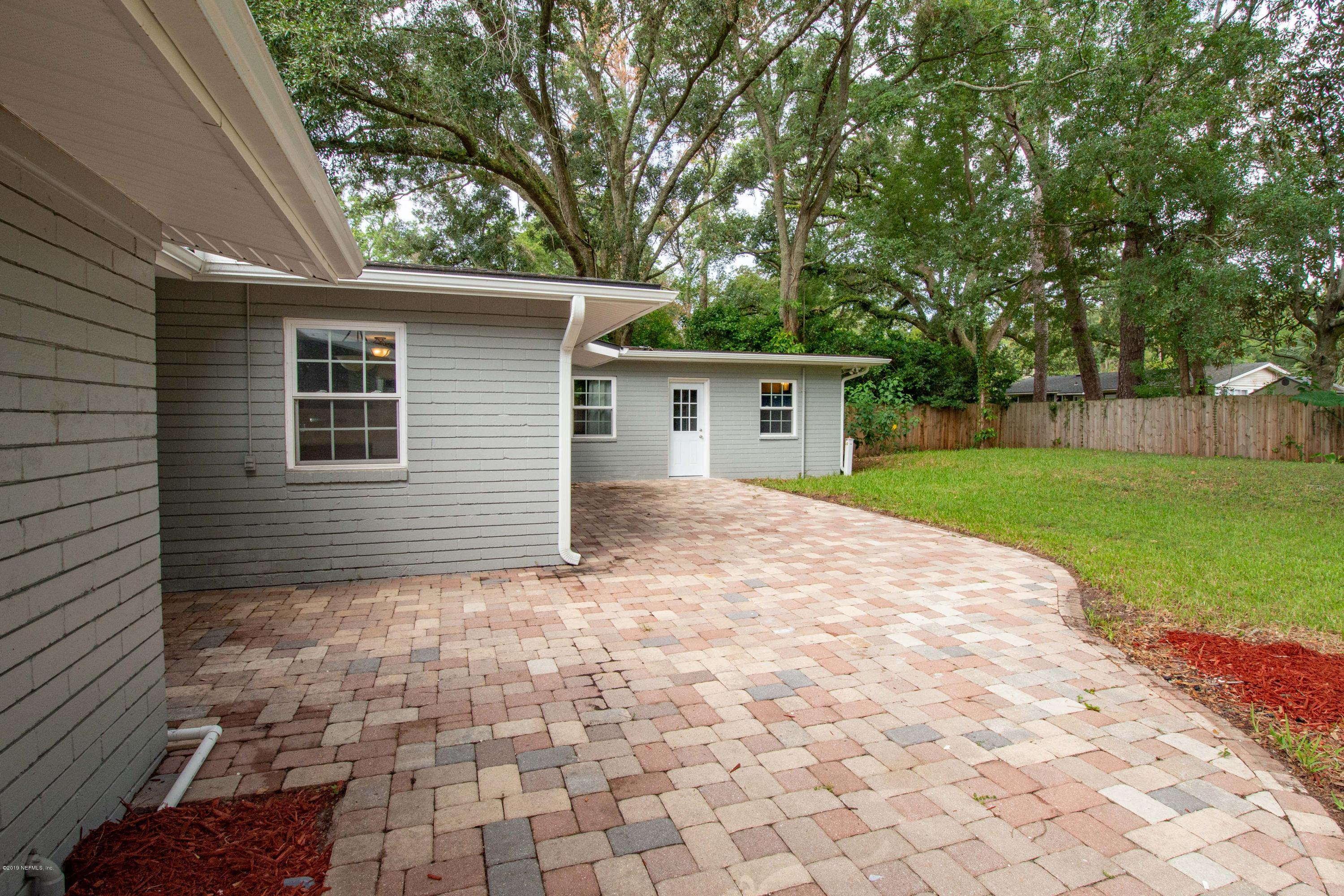4623 Martingale Road Jacksonville, FL 32210 - Photo 16 of 18 a backyard of a house with plants and large tree