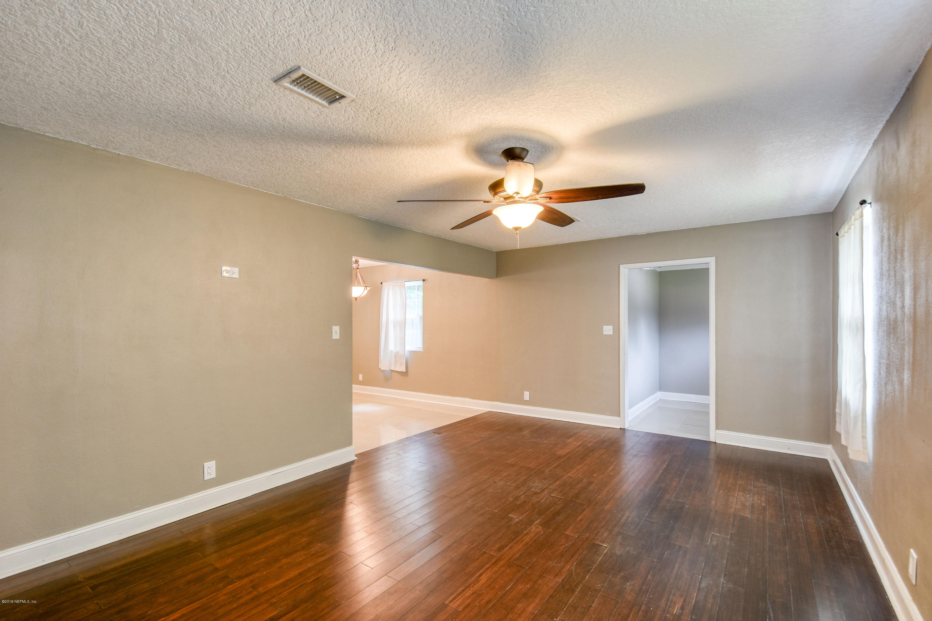 4623 Martingale Road Jacksonville, FL 32210 - Photo 3 of 18 a view of an empty room with wooden floor
