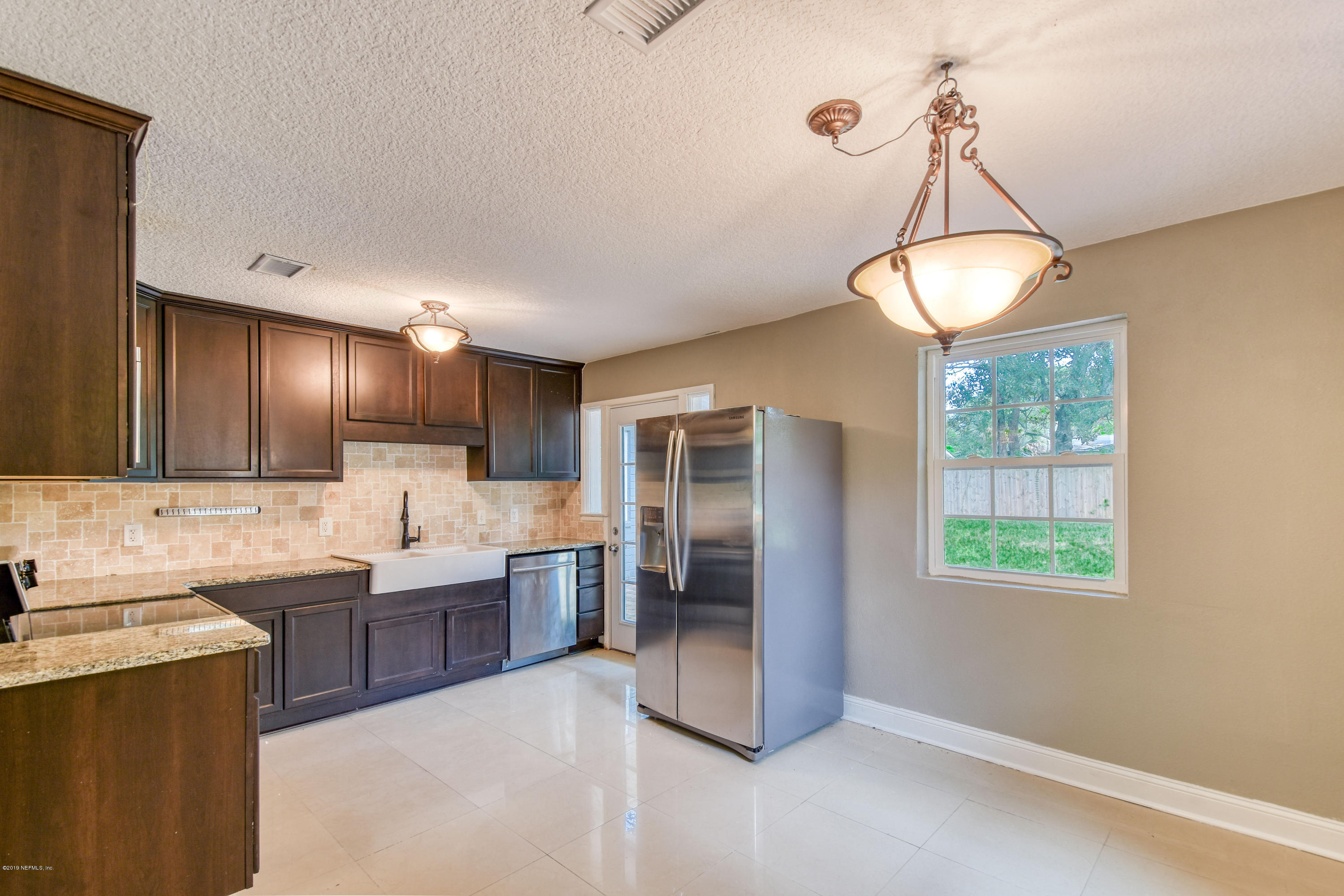 4623 Martingale Road Jacksonville, FL 32210 - Photo 5 of 18 a kitchen with lots of counter top space and appliances