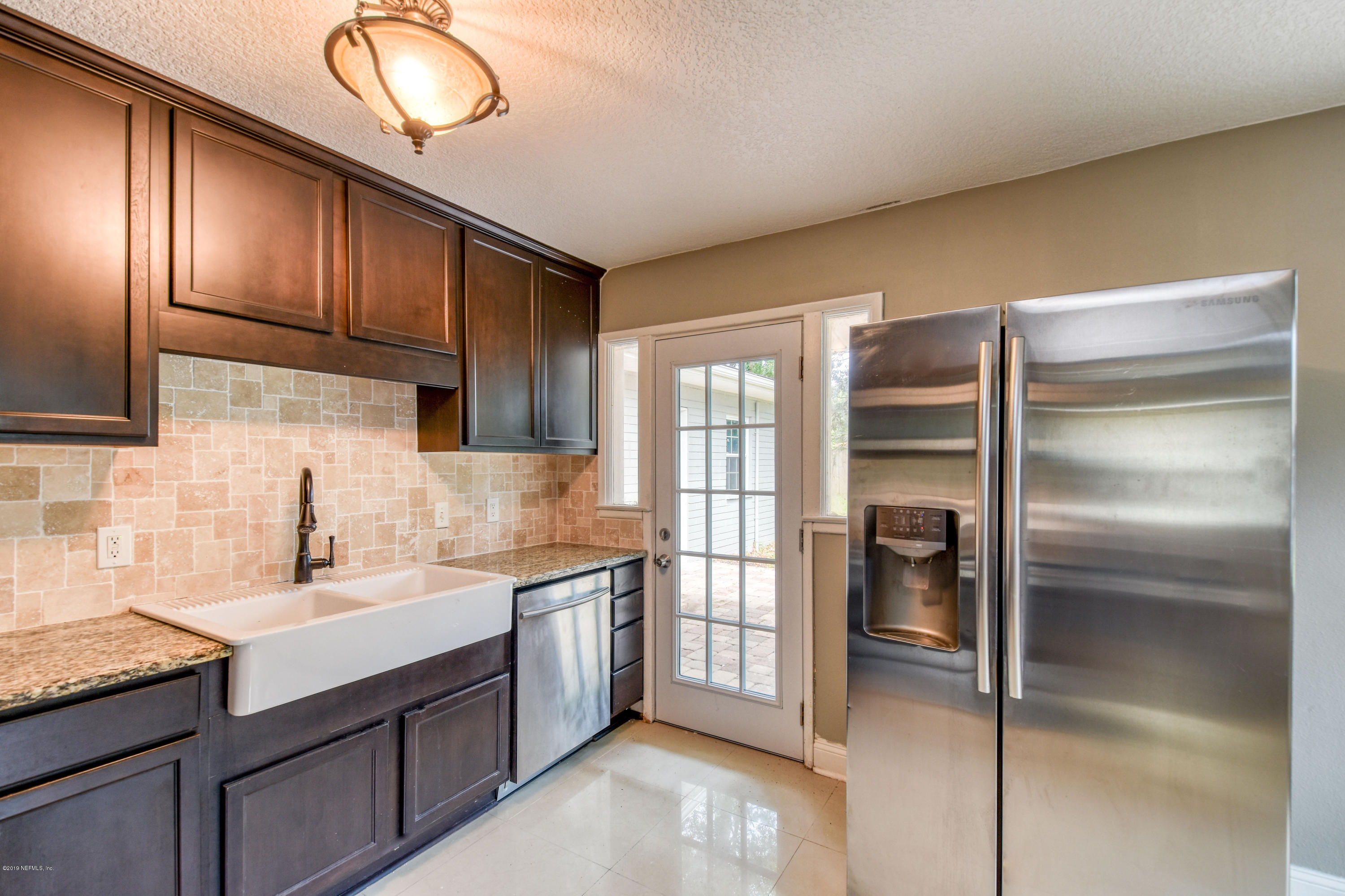 4623 Martingale Road Jacksonville, FL 32210 - Photo 7 of 18 a kitchen with cabinets and stainless steel appliances