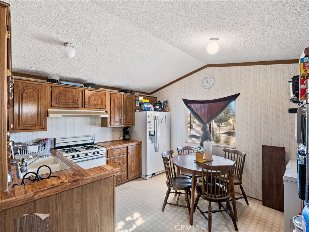 39626 East End Road Lucerne Valley, CA 92356 - Photo 12 of 29 a kitchen with a dining table and chairs