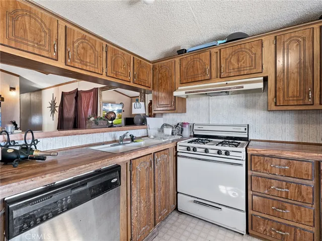 a kitchen with stainless steel appliances granite countertop a stove and a sink