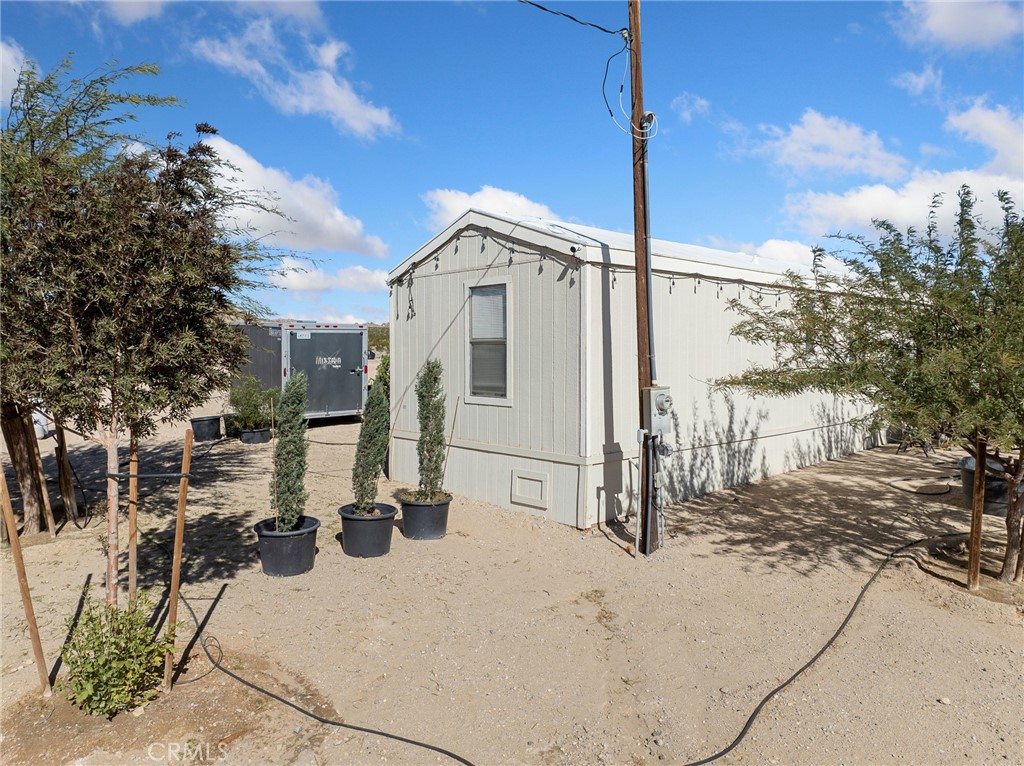 39626 East End Road Lucerne Valley, CA 92356 - Photo 20 of 29 a view of a white house with a yard