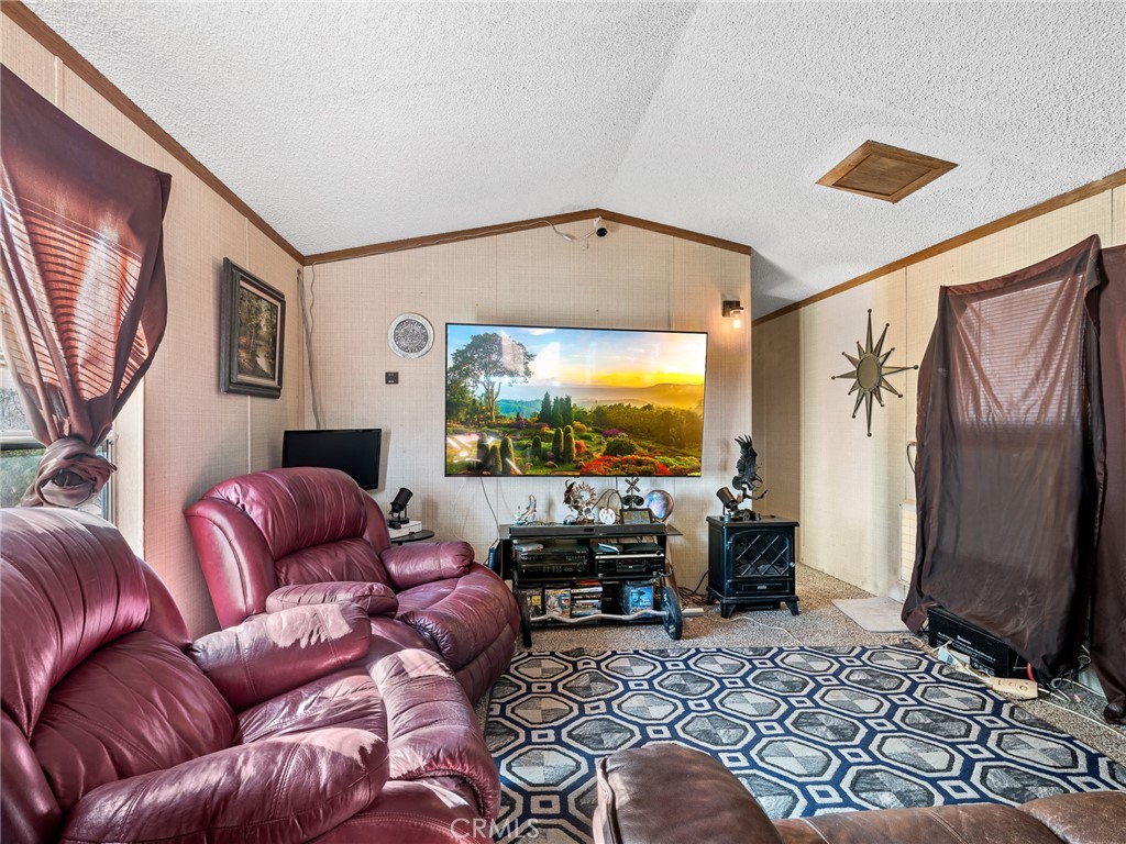 39626 East End Road Lucerne Valley, CA 92356 - Photo 5 of 29 a living room with furniture or couch and a flat screen tv