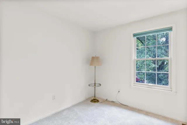 a bathroom with a granite countertop toilet sink and mirror
