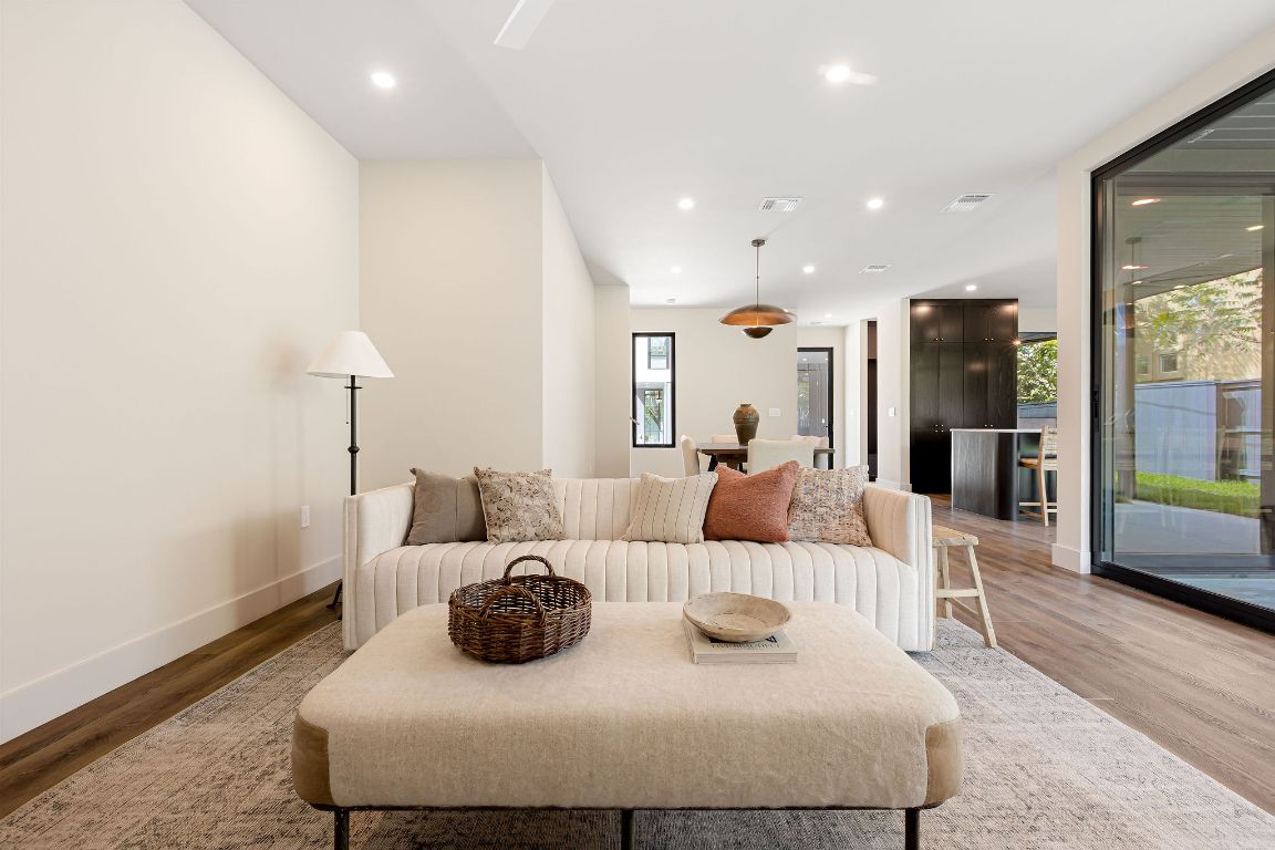 4412 Banister Lane, Unit 1 Austin, TX 78745 - Photo 15 of 40 a large bedroom with a bed and wooden floor