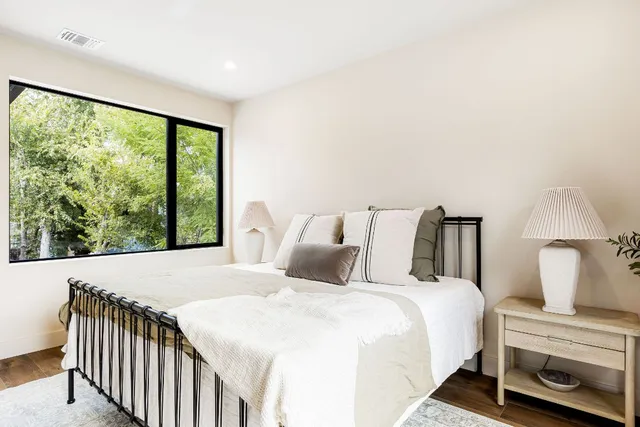 a bedroom with a large bed and a window