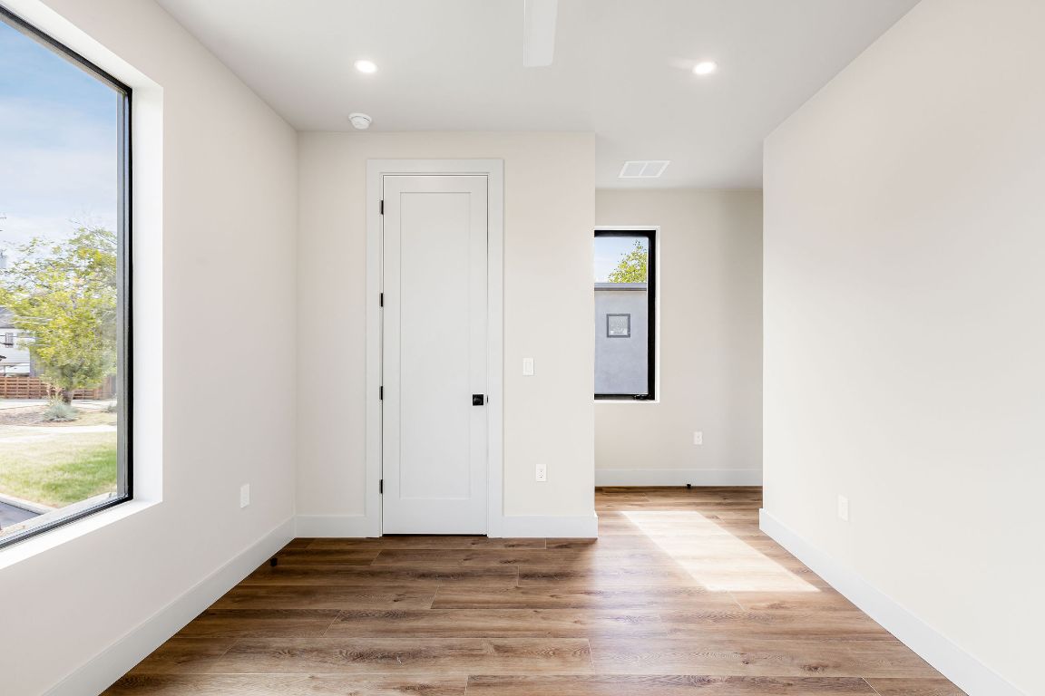 4412 Banister Lane, Unit 1 Austin, TX 78745 - Photo 39 of 40 an empty room with wooden floor and windows