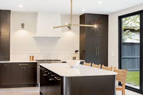 a kitchen with a sink a refrigerator and a stove