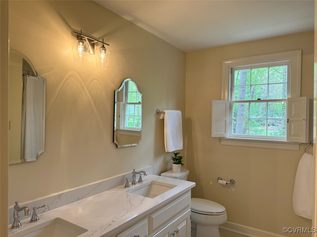 209 Running Cedar Lane Henrico, VA 23229 - Photo 22 of 29 a bathroom with a toilet sink and mirror